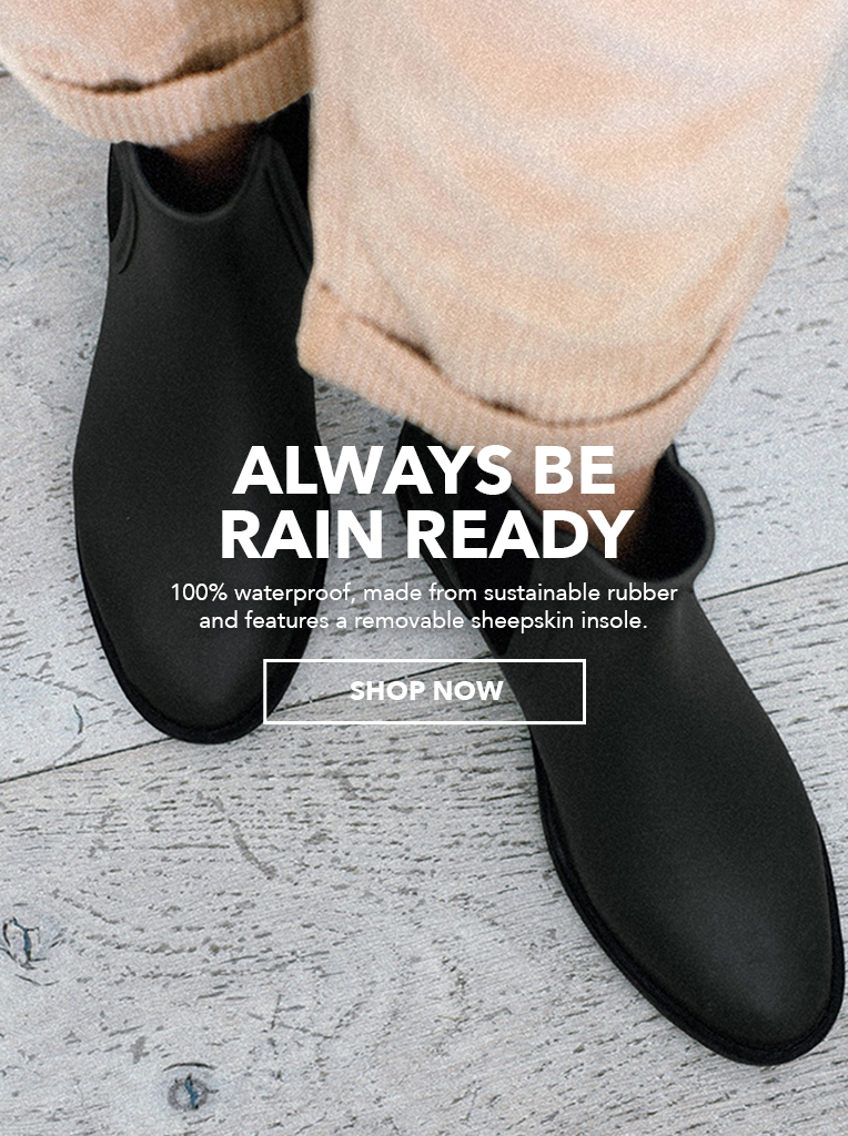 Girl wearing black rainboots. Always be rain ready, 100% Waterproof, made from sustainable rubber and features a removable sheepskin insole. Shop Now.