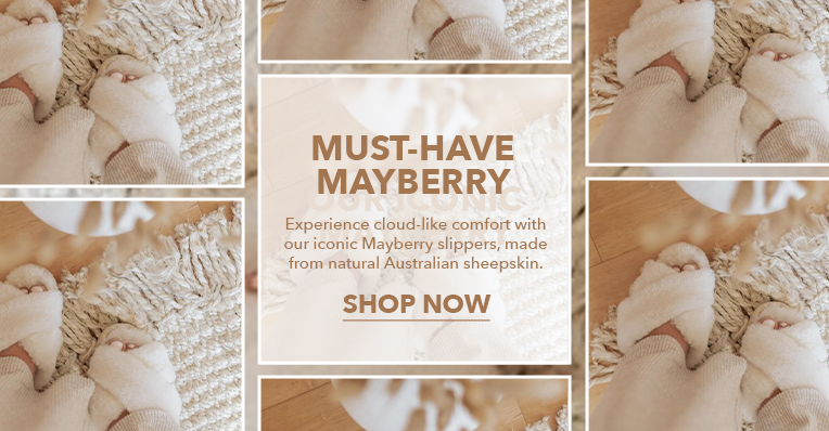 Woman at home standing on wovan rug and floorboards wearing EMU Mayberry Natural slippers