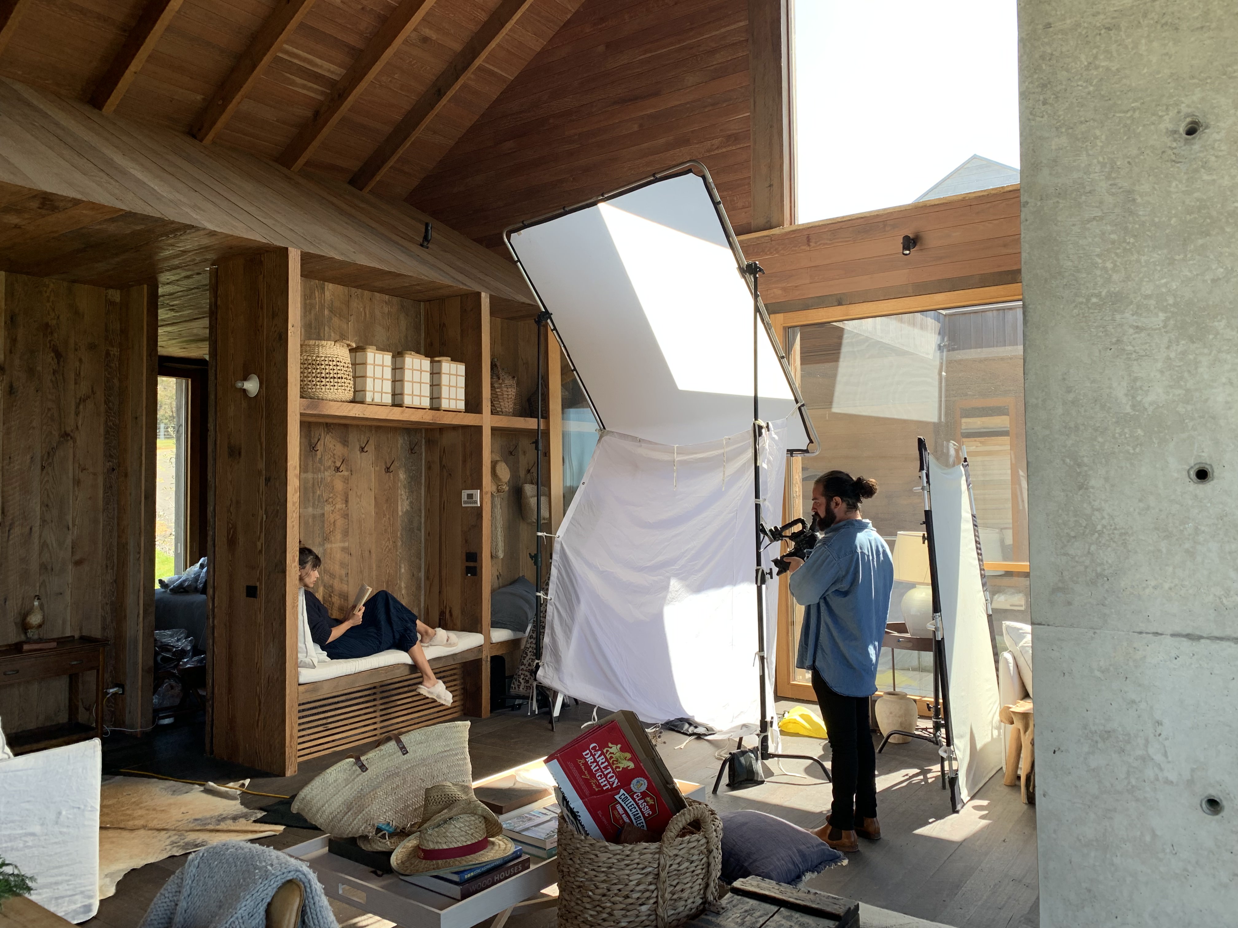 Behind the scenes of photoshoot showing photographer and model wearing Wobbegong sheepskin slippers