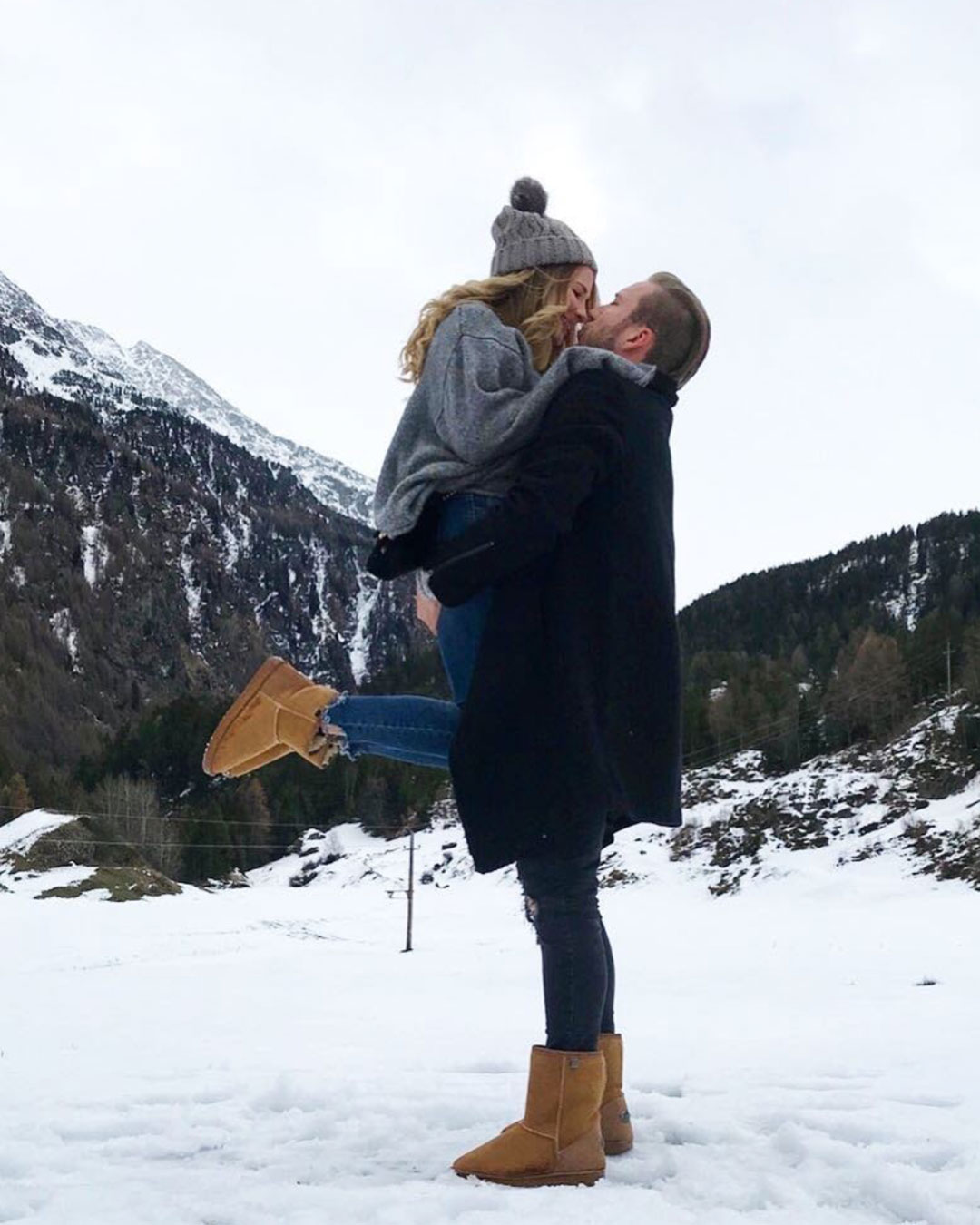 Couple embracing in snow wearing matching unisex sheepskin boots