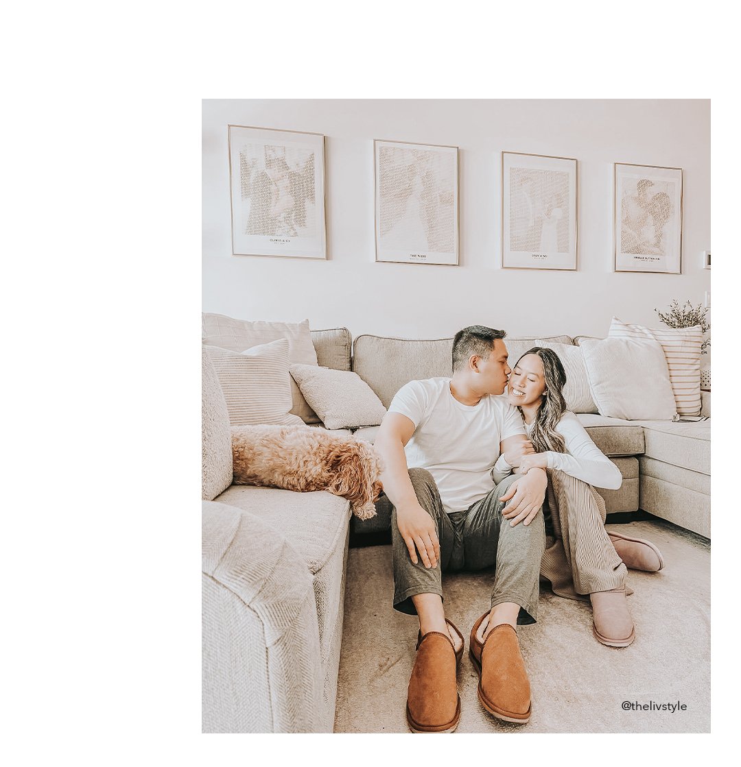 Cute couple sitting on floor in living room wearing cosy sheepskin slippers.