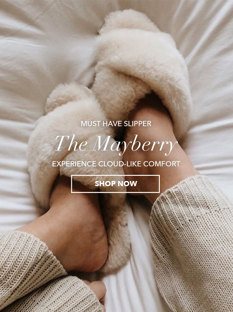 Girl wearing Mayberry sheepskin slippers. Must-have slipper: The Mayberry. Experience cloud-like comfort. Shop Now.